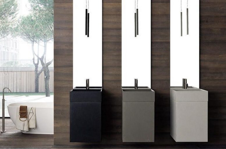 Basi e lavelli si vestono di resina, in un gioco cromatico di tendenza che va dal nero al cendre e al grigio, in aperto contrasto con la libreria laccata bianco satinato.