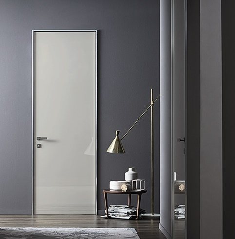 Linea sofisticata, che dona originalità alla stanza grazie al contrasto tra l’effetto di profondità dello stipite in alluminio e la perfetta complanarità
di parete e anta.
